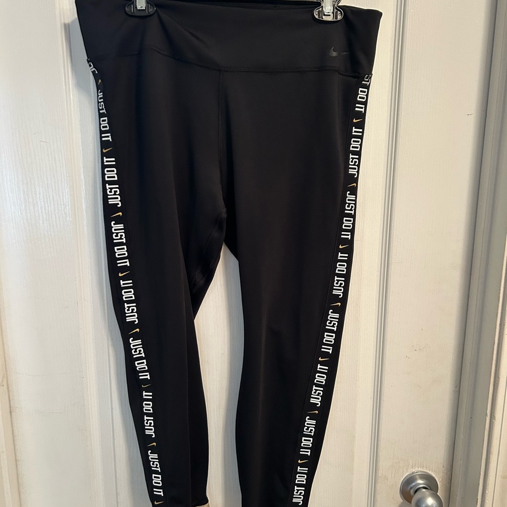 Nike Black Leggings Premium Performance Wear with Gold Cuffs and Logo detail